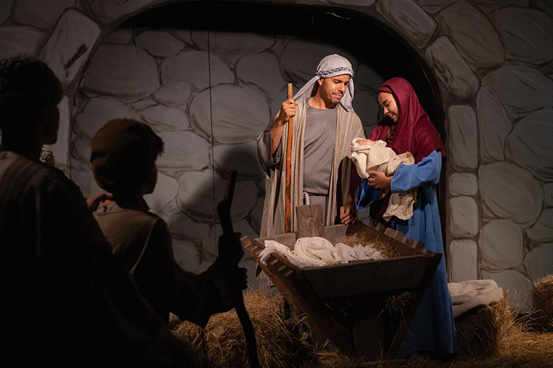 Mary and Joseph holding baby Jesus